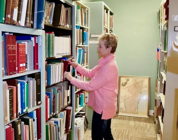 Woman shelving in stacks